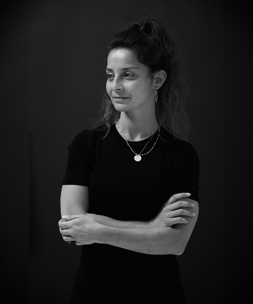 Melissa Rezaei, stood against black background at SHED london photography studio and desk space